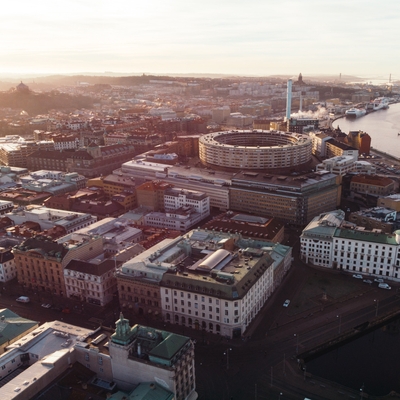 <p>Overview image of a city, shot in low sunlight from a far distance.</p>
